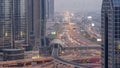 Busy Sheikh Zayed Road aerial day to night , metro railway and modern skyscrapers around in luxury Dubai city. Royalty Free Stock Photo