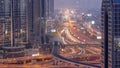 Busy Sheikh Zayed Road aerial day to night timelapse, metro railway and modern skyscrapers around in luxury Dubai city. Royalty Free Stock Photo