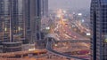 Busy Sheikh Zayed Road aerial day to night timelapse, metro railway and modern skyscrapers around in luxury Dubai city. Royalty Free Stock Photo