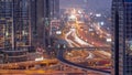 Busy Sheikh Zayed Road aerial day to night timelapse, metro railway and modern skyscrapers around in luxury Dubai city. Royalty Free Stock Photo
