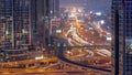 Busy Sheikh Zayed Road aerial day to night timelapse, metro railway and modern skyscrapers around in luxury Dubai city. Royalty Free Stock Photo