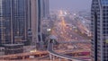 Busy Sheikh Zayed Road aerial night to day , metro railway and modern skyscrapers around in luxury Dubai city. Royalty Free Stock Photo