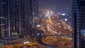 Busy Sheikh Zayed Road aerial night to day timelapse, metro railway and modern skyscrapers around in luxury Dubai city. Royalty Free Stock Photo