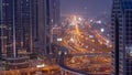 Busy Sheikh Zayed Road aerial night to day timelapse, metro railway and modern skyscrapers around in luxury Dubai city. Royalty Free Stock Photo