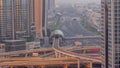 Busy Sheikh Zayed Road aerial night to day timelapse, metro railway and modern skyscrapers around in luxury Dubai city. Royalty Free Stock Photo