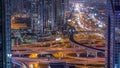 Busy Sheikh Zayed Road intersection aerial night timelapse, metro railway and modern skyscrapers around in luxury Dubai Royalty Free Stock Photo