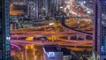 Busy Sheikh Zayed Road intersection aerial night timelapse, metro railway and modern skyscrapers around in luxury Dubai Royalty Free Stock Photo