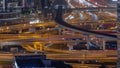 Busy Sheikh Zayed Road junction aerial night timelapse, metro railway and modern skyscrapers around in Dubai city. Royalty Free Stock Photo