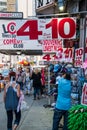 Busy sidewalk in Times Square, Manhattan New York City. Many tourist souvenir shops and a comedy club sign is seen Royalty Free Stock Photo