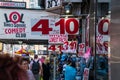 Busy sidewalk in Times Square, Manhattan New York City. Many tourist souvenir shops and a comedy club sign is seen Royalty Free Stock Photo