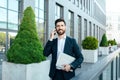 Busy smiling confident young caucasian businessman with beard in suit with laptop, call by smartphone Royalty Free Stock Photo