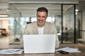 Happy middle aged professional business man using computer working at desk. Royalty Free Stock Photo