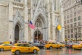 Busy St. Patrick`s Cathedral on Christmas Season in Manhattan, New York City. Busy Avenue Full of Yellow Taxis  and Vehicles. Royalty Free Stock Photo