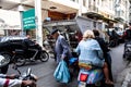 Busy street with cars, mopeds and people in Athens, Greece.