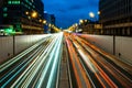 Busy street in the city at dusk, full of car light streaks dynamic blue hour shot with long exposure Royalty Free Stock Photo