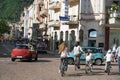 Busy street in Merano, Italy after lock-down. Bicyclists and cars in May of 2020 on Theatre Square.