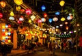 Busy street with people in Hoian ancient town center with famous traditional paper lantern lamps creating beautiful atmosphere at