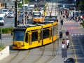 Busy streetscape of Budapest, Hungary in early fall. yellow trams and many pedestrians