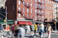 Busy street scene with crowds of people walking through the intersection on 7th Avenue and Bleecker in the Greenwich Village Royalty Free Stock Photo