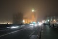 Busy street with traffic and pedestrians at foggy night in London Royalty Free Stock Photo