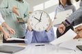 Busy stressed office worker with clock face is asked to do lots of tasks at work Royalty Free Stock Photo