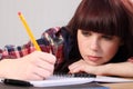 Busy student girl writing homework with pencil Royalty Free Stock Photo