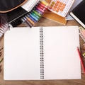 Busy students desk with blank open notebook Royalty Free Stock Photo