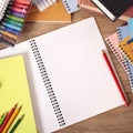 Busy students desk with blank open notebook Royalty Free Stock Photo