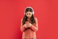 busy teen girl in earphones messaging smartphone. modern life in childhood.