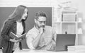 busy teen girl and teacher man in high school with workbook and pc at blackboard, education online