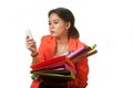 Busy Asian business woman with a lot of folders and colorful papers on isolated background. Royalty Free Stock Photo