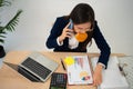 Busy and tired businesswoman eating Bread and milk for lunch at the Desk office and working to deliver financial statements to a Royalty Free Stock Photo