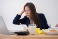 Busy and tired businesswoman eating spaghetti for lunch at the Desk office and working to deliver financial statements to a boss. Royalty Free Stock Photo