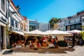 Busy touristic restaurants and bars area in the center of Cascais with traditional Portuguese architecture