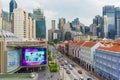 Busy traffic in Chinatown Singapore with skyscrappers