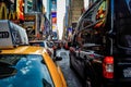 Busy traffic pulsing through the Times Square in New York City. Road full of cars  yellow cabs and sounds. Crossing the street. Royalty Free Stock Photo