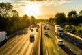 Busy traffic on uk motorway road overhead view at sunset