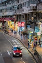 Busy urban street at night with traffic and pedestrians in Hong Kong. Royalty Free Stock Photo