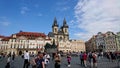 A busy view of tourists walking in the Old Town Square with Pamatnik Jana Husa in the front and Chram Matky Bozi pred Royalty Free Stock Photo