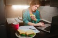 Busy woman eating, drinking coffee, talking on the phone, working on a laptop at the same time. Businesswoman doing Royalty Free Stock Photo