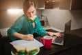 Busy woman eating, drinking coffee, talking on the phone, working on a laptop at the same time. Businesswoman doing Royalty Free Stock Photo