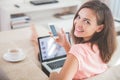 Busy woman at home using mobile phone and laptop at the same tim Royalty Free Stock Photo