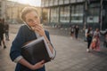 Busy woman is in a hurry, she does not have time, she is going to eat snack on the go. Worker eating, drinking coffee Royalty Free Stock Photo