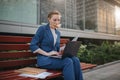 Busy woman is in a hurry, she does not have time, she is going to eat snack outdoors. Worker eating and working with Royalty Free Stock Photo