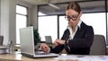 Busy woman looking at watch, confused by failing urgent task, missing deadline