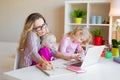 Busy woman trying to work while babysitting two kids Royalty Free Stock Photo