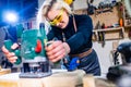 Busy wood designer in a small carpentry workshop