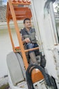 Busy worker driving forklift