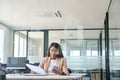 Business woman using mobile working with papers in office. View through glass Royalty Free Stock Photo