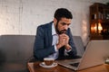 Busy young businessman having coffee and doing his work. Royalty Free Stock Photo